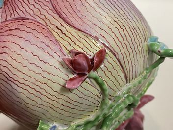 Een Chinese famille rose lotusvormige kop en schotel met reli&euml;fdecor, Yongzheng