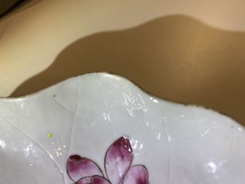 Een Chinese famille rose lotusvormige kop en schotel met reli&euml;fdecor, Yongzheng