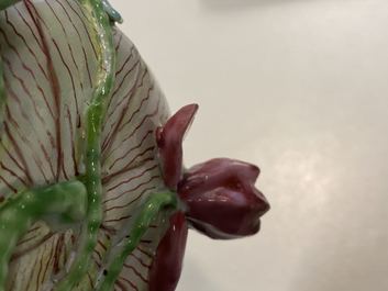Een Chinese famille rose lotusvormige kop en schotel met reli&euml;fdecor, Yongzheng