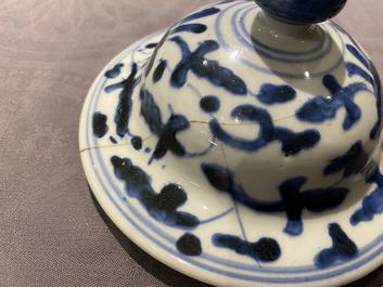 A pair of Chinese blue and white 'lotus scroll' vases and covers, Kangxi