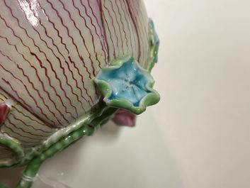 Een Chinese famille rose lotusvormige kop en schotel met reli&euml;fdecor, Yongzheng