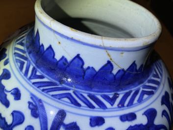 A pair of Chinese blue and white 'lotus scroll' vases and covers, Kangxi