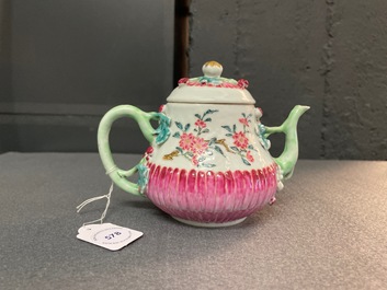 A Chinese famille rose teapot on stand with applied floral design, Yongzheng