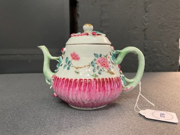 A Chinese famille rose teapot on stand with applied floral design, Yongzheng