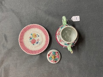 A Chinese famille rose teapot on stand with applied floral design, Yongzheng