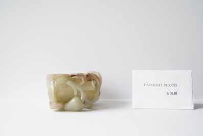 A Chinese mottled celadon and brown jade peach-form brush washer, Qing