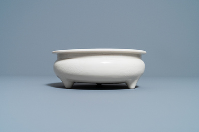 A Chinese Dehua blanc de Chine tripod censer with an incised design, Kangxi