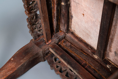 A Chinese carved wooden stand with marble top, 19th C.