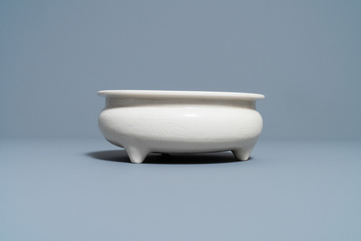 A Chinese Dehua blanc de Chine tripod censer with an incised design, Kangxi