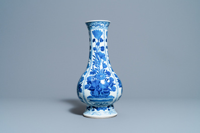 A Chinese blue and white bottle vase with flower arrangements, Kangxi