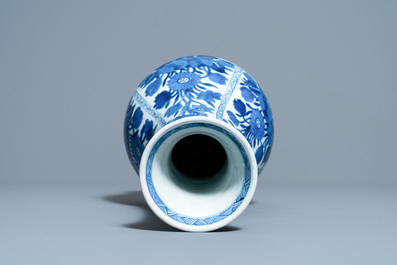 A Chinese blue and white bottle vase with flower arrangements, Kangxi
