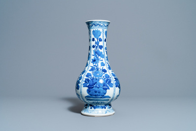 A Chinese blue and white bottle vase with flower arrangements, Kangxi