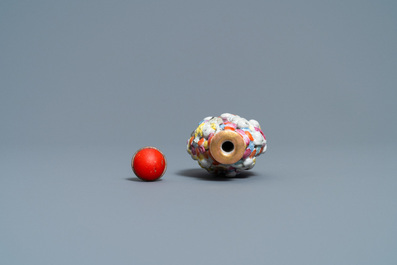 A Chinese famille rose molded, reticulated and double-walled '18 Luohans' snuff bottle, Qianlong mark, 19th C.