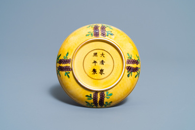Une coupe en porcelaine de Chine &agrave; d&eacute;cor de dragons en vert et aubergine sur fond jaune, marque et &eacute;poque de Kangxi