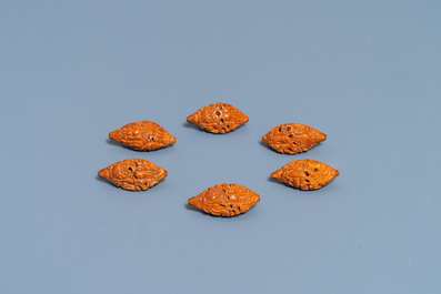 Six Chinese carved fruit pits, a walnut snuff bottle and a gourd cricket box, 19/20th C.
