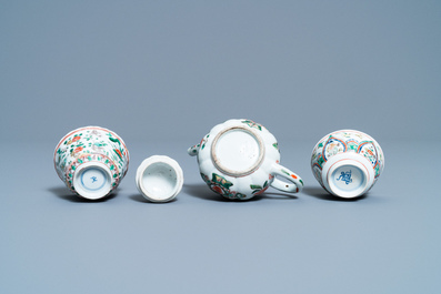 A Chinese famille verte teapot, two cups and three saucers, Kangxi