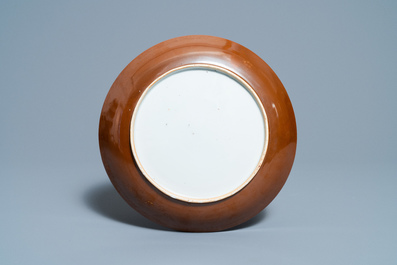 A Chinese famille verte 'mandarin ducks' dish with an incised lotus design, Kangxi
