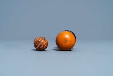 Six Chinese carved fruit pits, a walnut snuff bottle and a gourd cricket box, 19/20th C.