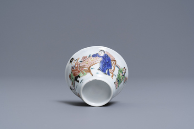 A Chinese famille rose 'tea scene' cup and saucer, Yongzheng/Qianlong