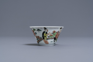 A Chinese famille rose 'tea scene' cup and saucer, Yongzheng/Qianlong