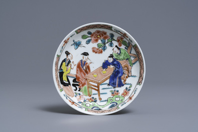 A Chinese famille rose 'tea scene' cup and saucer, Yongzheng/Qianlong
