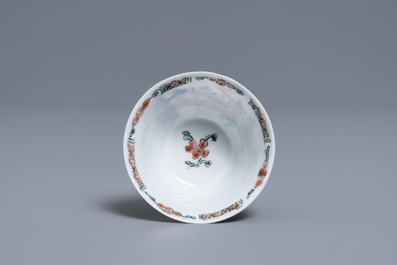 A Chinese famille rose 'tea scene' cup and saucer, Yongzheng/Qianlong