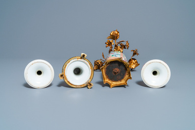 Three Chinese Canton famille rose candlesticks and a vase with gilt bronze mounts, 19th C.