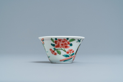 A Chinese famille rose 'tea scene' cup and saucer, Yongzheng/Qianlong