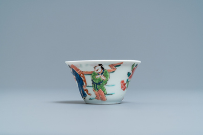 A Chinese famille rose 'tea scene' cup and saucer, Yongzheng/Qianlong