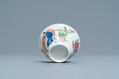 A Chinese famille rose 'tea scene' cup and saucer, Yongzheng/Qianlong