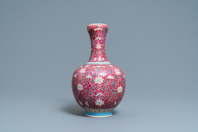 A Chinese famille rose ruby-ground bottle vase, Qianlong mark, 19/20th C.