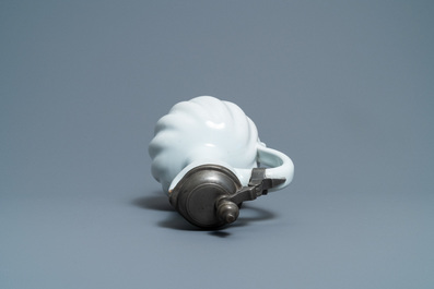 A large gadrooned white Dutch Delftware jug with pewter cover, 17th C.