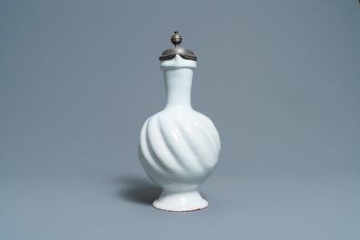 A large gadrooned white Dutch Delftware jug with pewter cover, 17th C.