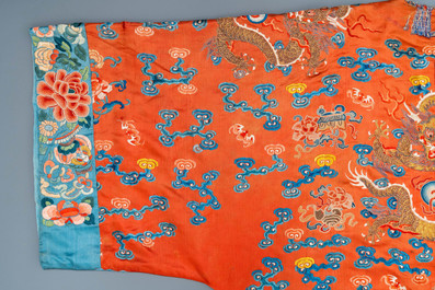 A Chinese embroidered silk red-ground 'dragon' robe, 19th C.