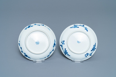 A pair of Chinese blue and white 'Caritas' cups and saucers, Kangxi/Yongzheng