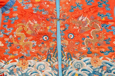 A Chinese embroidered silk red-ground 'dragon' robe, 19th C.