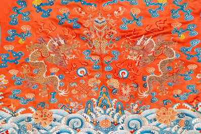 A Chinese embroidered silk red-ground 'dragon' robe, 19th C.
