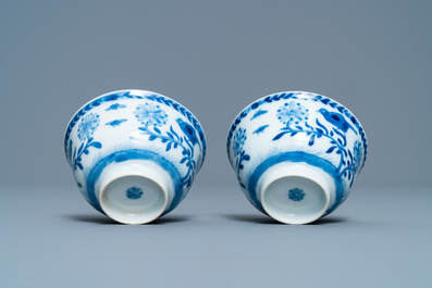 A pair of Chinese blue and white 'Caritas' cups and saucers, Kangxi/Yongzheng