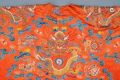 A Chinese embroidered silk red-ground 'dragon' robe, 19th C.