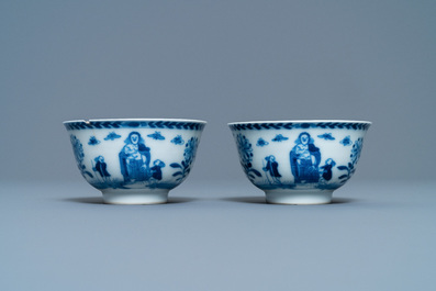 A pair of Chinese blue and white 'Caritas' cups and saucers, Kangxi/Yongzheng
