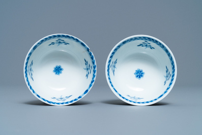 A pair of Chinese blue and white 'Caritas' cups and saucers, Kangxi/Yongzheng