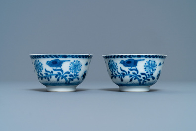 A pair of Chinese blue and white 'Caritas' cups and saucers, Kangxi/Yongzheng