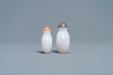 A Chinese white jade coral-topped snuff bottle and one in glass with inclusions, 19th C.
