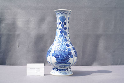 A Chinese blue and white bottle vase with flower arrangements, Kangxi