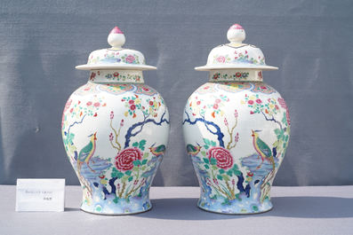 A pair of Chinese famille rose 'pheasants' vases and covers, 19th C.