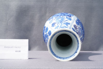 A Chinese blue and white bottle vase with flower arrangements, Kangxi