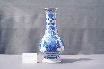 A Chinese blue and white bottle vase with flower arrangements, Kangxi