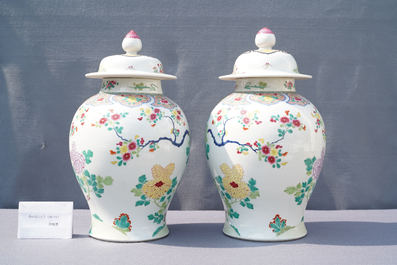 A pair of Chinese famille rose 'pheasants' vases and covers, 19th C.