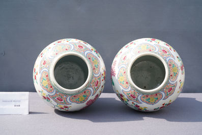A pair of Chinese famille rose 'pheasants' vases and covers, 19th C.
