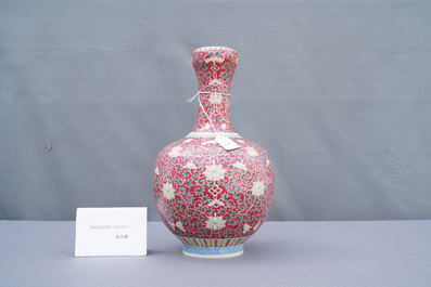 A Chinese famille rose ruby-ground bottle vase, Qianlong mark, 19/20th C.